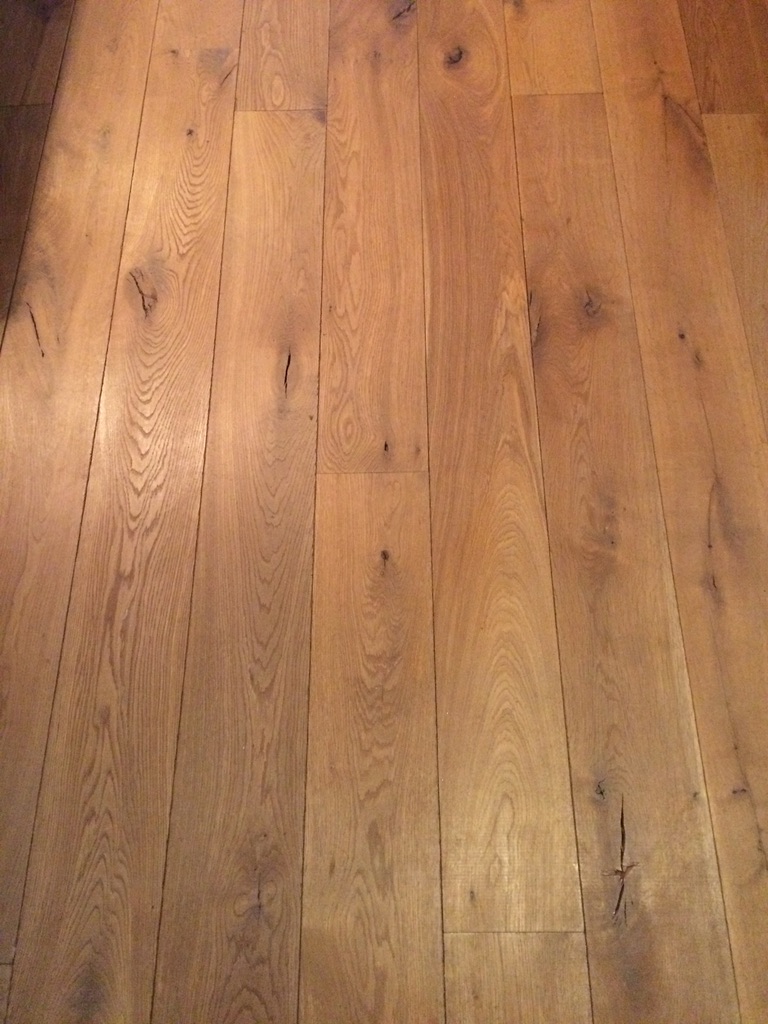 Close-up of wide-plank engineered oak flooring with natural grain and knots