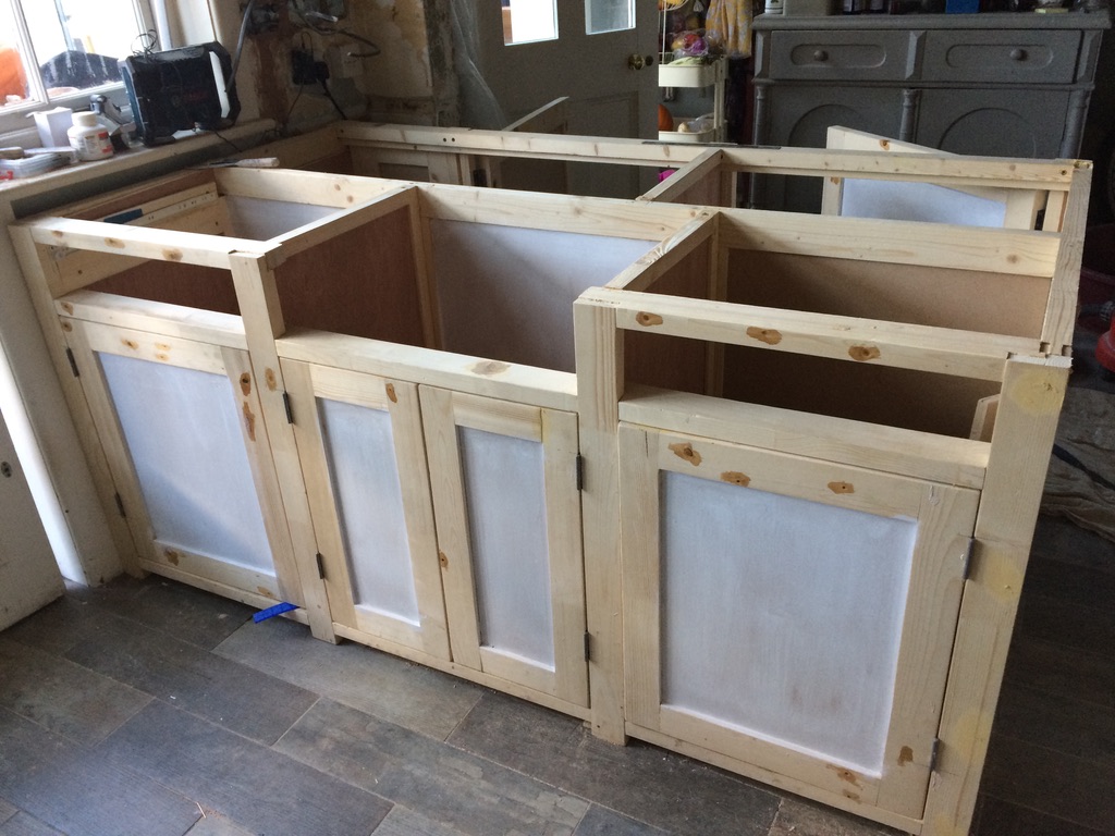 Hand-built solid timber kitchen cabinet carcasses with framed doors, part-finished in the workshop